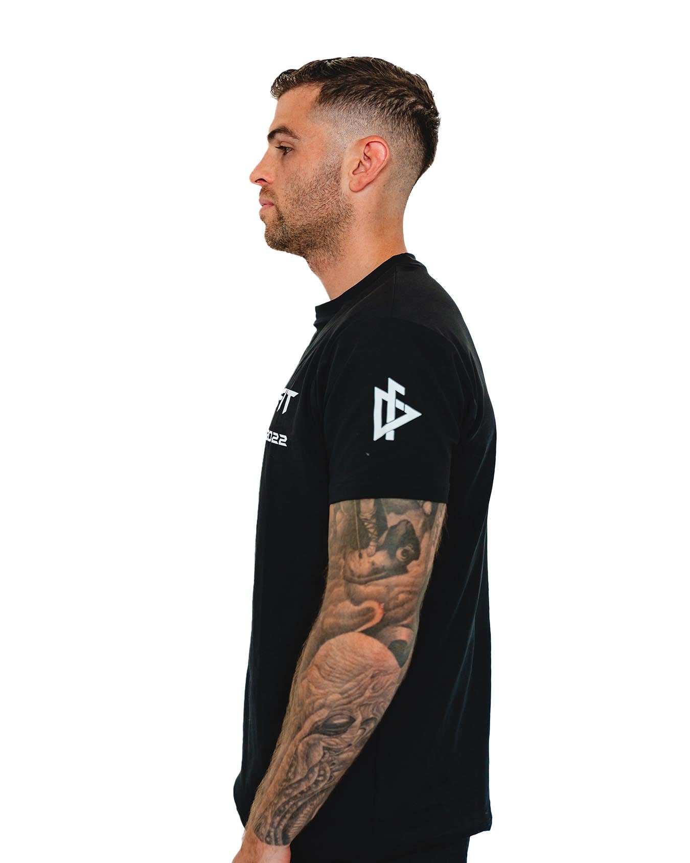 Male model performing dumbbell curls in the DeemedFit Compellence tee
