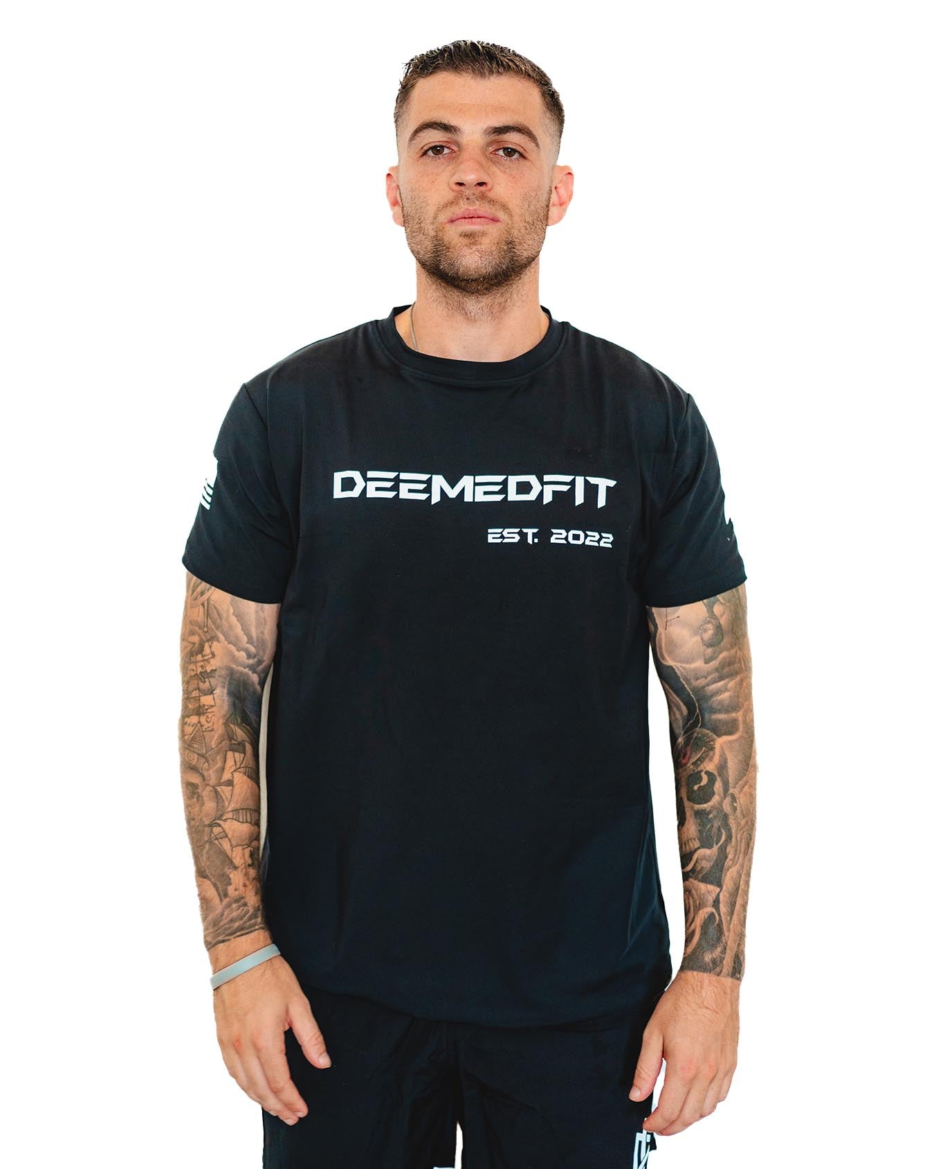 Front view of a male model wearing the DeemedFit "Compellence" black gym tee