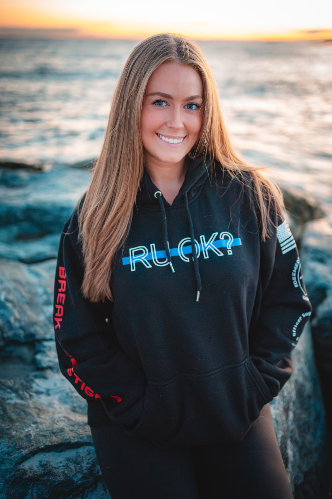 Black hoodie with text and graphics on the back and sleeve
