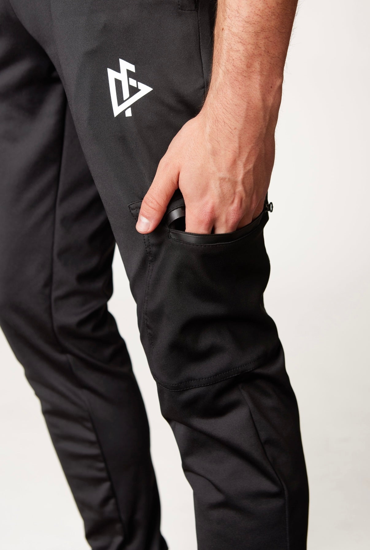 Model running in DeemedFit Performance Tech Joggers demonstrating flexibility and movement.