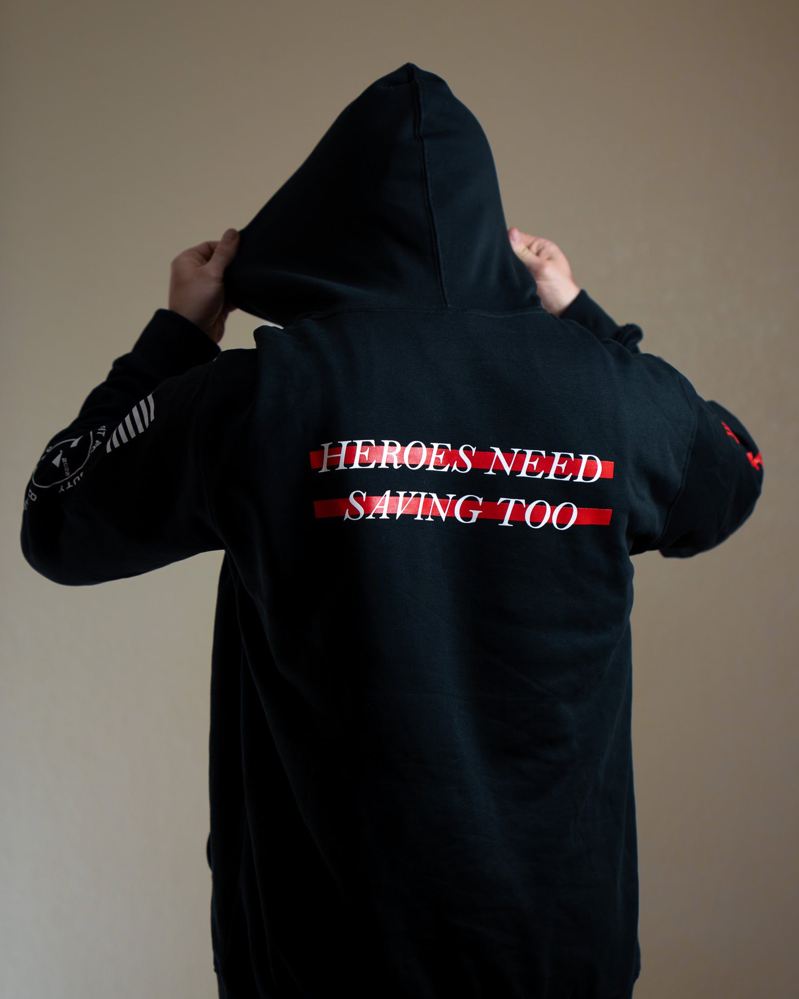 Black hoodie with text on the back against a plain background