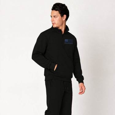 Black Blue Line quarter zip pullover worn by a model, angled front view