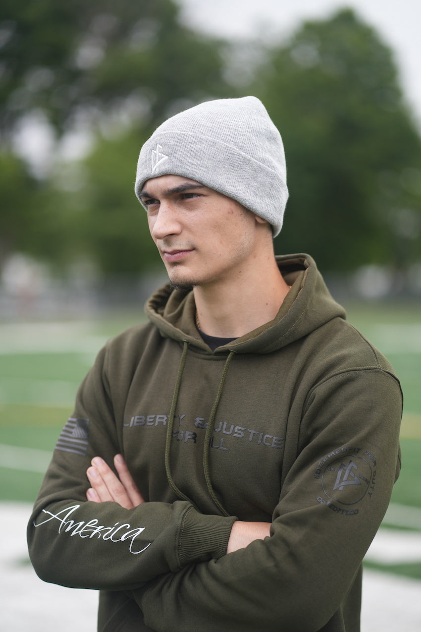 Young man with Beanie Hat Cuffed Grey with DeemedFit logo on front